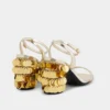 Goldene Sandalen mit glitzernden Scheibenabsätzen